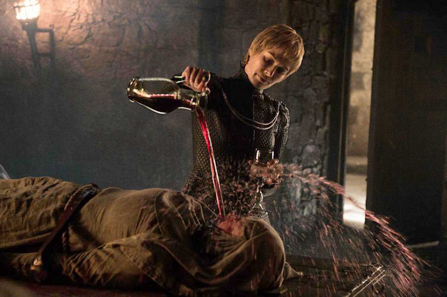 Lena Heady as Cersei pouring wine on Hanna Waddington in a scene from Game of Thrones (photo credit: HBO)